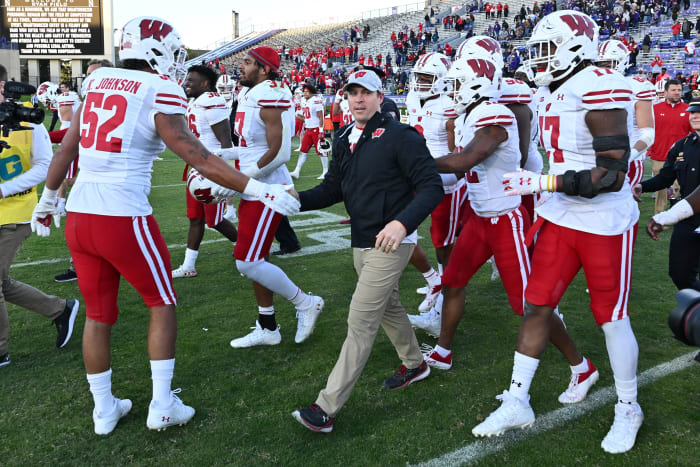 Wisconsin head coach Jim Leonhard celebrating a win with his team.